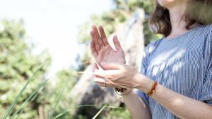 Advanced practitioner demonstrating EFT Tapping points for health anxiety relief in nature